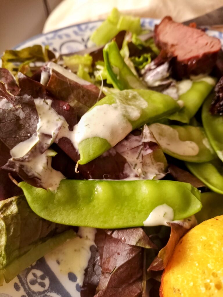 Peas atop a salad with homemade ranch